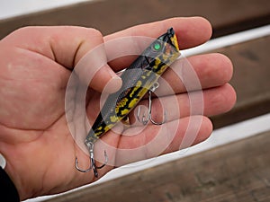 Fishing lures and accessories in the box background. Focus in the center of the bait