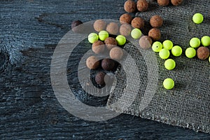 Fishing lures boilies on an old wooden background, preparing for fishing