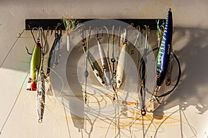 Fishing lures hang on the hull of a charter fishing vessel.