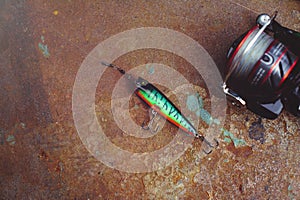 Fishing lures with large hooks, plastic fishing lures fishing tackle. Jelly. Wobbler on a background of wood with two hooks. Photo