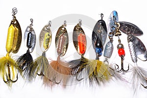 Fishing lures in a line on whi