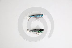 Fishing lures in the shape of fish isolated on a grey background