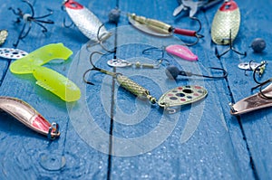 Fishing lures for spinning. Front view. Tee, lure, soft bait, wobblers. Water drops.