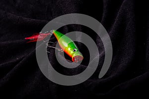 Fishing lures on on various black background background. Fishing fake bait are another alternative to angling. used in conjunctio