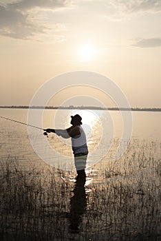 Fishing man at sunset.