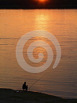 Fishing man at sunset