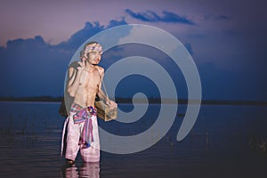 Fishing man use bamboo fish trap to catch fish