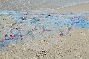 Fishing net is on the beach.