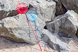 fishing net or butterfly net on a stone near the beach photo