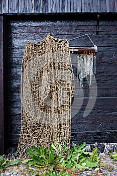 Fishing Net draped loosely Alongside A Row Of Big Game Fish Hooks