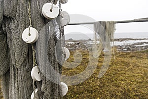 Fishing net is dried on wooden stanchions