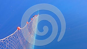 Fishing Net Hanging From Boat Under Sea in Underwater