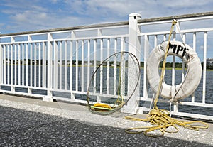 Fishing Net and Life Preserver Hung on Pier with Yellow Rope