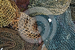 A fishing net is a net used for fishing. Nets are devices made from fibers woven in a grid-like structure. Some fishing