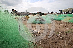 Fishing nets and african fishing boats at the shore. Fishing industry in West Africa. Industry and artisan fishing context