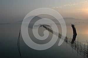 Fishing nets on calm lake photo