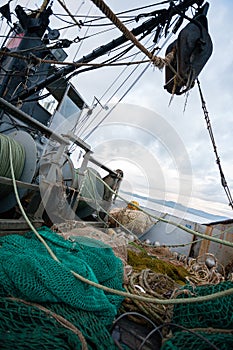Fishing nets are on the deck of a small fishing vessel