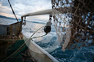 Fishing nets are on the deck of a small fishing vessel