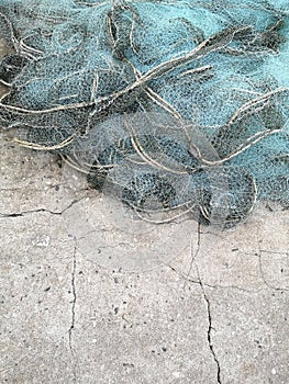 Fishing nets drying in the sun.Trawl of fisherman or net on the shore at fisherman village before storm.