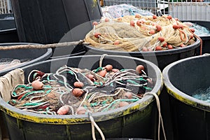 Fishing nets inside huge plastic bins close up