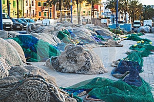 Fishing nets in port blue and green color not in use stacked together for renovation photo