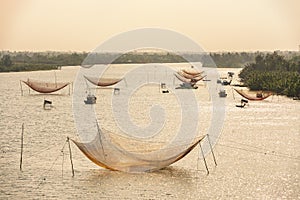 Fishing nets on the river, in Cua Dai fishing village photo