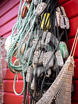 Fishing nets and ropes hang outside on the house wall