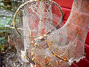 Fishing nets and ropes hang outside on the house wall