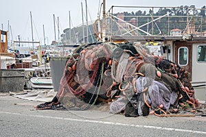 Fishing nets stacked on the waterfront