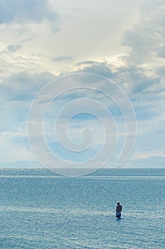 Fishing in the open sea - A man with a fishing rod catches fish in the sea