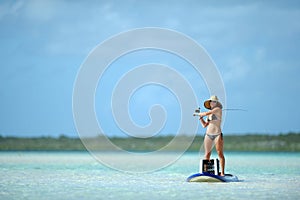 Fishing and paddleboarding in tropical destination photo