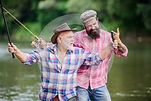 Fishing peaceful activity. Father and son fishing. Grandpa and mature man friends. Fisherman family. Rod tackle. Fishing