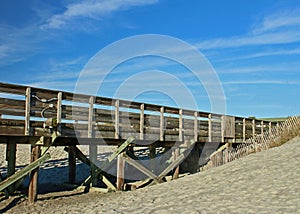 Fishing pier meets sand dune