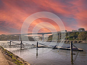 Fishing pier near the river beach of Areinho on the bank of Gaia on the Douro river at sunset. Portugal photo