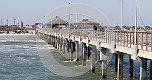 Fishing pier view back to shore and sandy beach Texas 4k