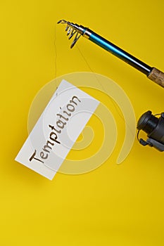 Fishing pole with paper and word TEMPTATION