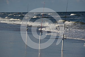 Fishing poles line the ocean surf along the North Florida coastline