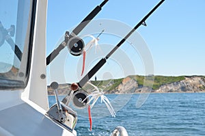 Fishing poles, reels and lures on a charter fishing boat.