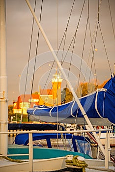 Fishing port of Ustka, with old lighthouse in warm evenin