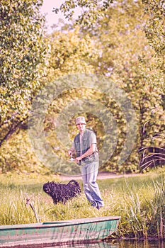 Fishing- portrait of fisherman and his dog