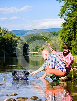 Fishing and recreation. big game fishing. Two male friends fishing together. fly fish hobby of men. retirement fishery