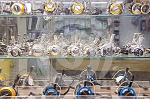 Fishing reels in a tackle shop glass cabinet