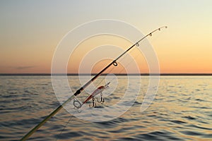 fishing rod against the evening sky