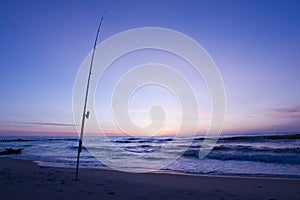 Fishing rod on the beach photo