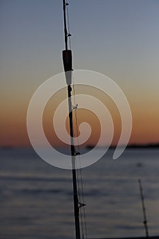 Fishing rod with blurred scene of sunset