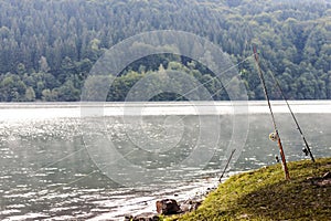 Fishing rod equipment on a lake in misty spring morning