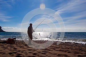 Fishing rod lake fisherman men sport summer lure sunset water outdoor sunrise fish - stock image.