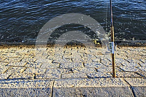 Fishing rod leaning on the shore of the Tagus River