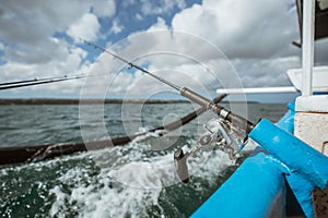 fishing rod mounted on a small fishing boat while fishing