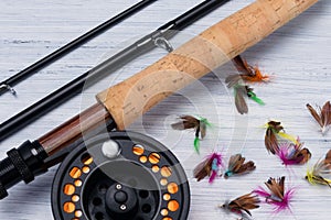 Fishing rod with reel and various baits for fishing close-up